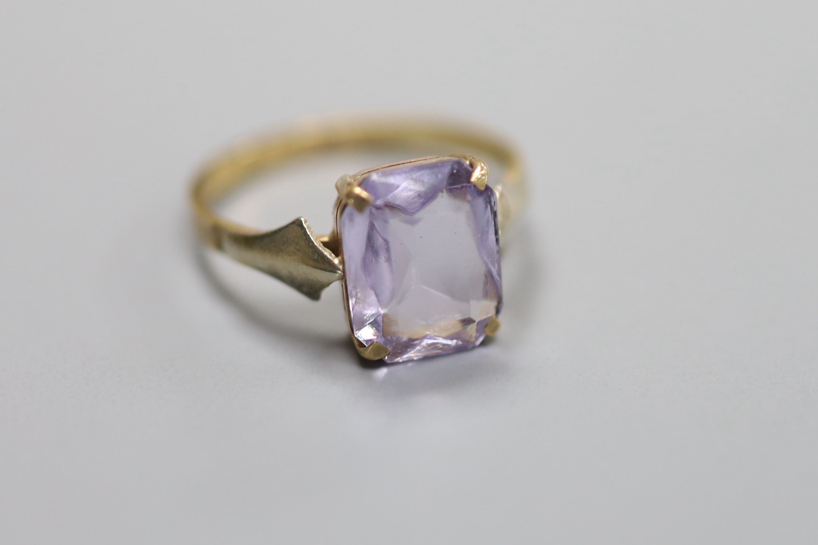 Three assorted 9ct and amethyst set dress rings, including amethyst and diamond and amethyst and seed pearl and one 9ct and amethyst paste ring.